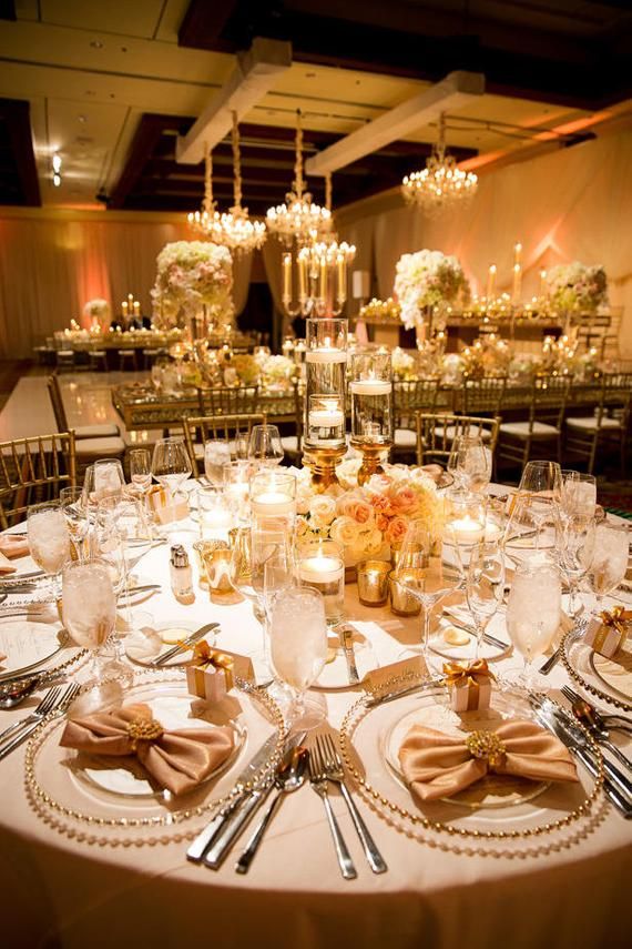 the table is set with silverware, candles and napkins for an elegant wedding reception