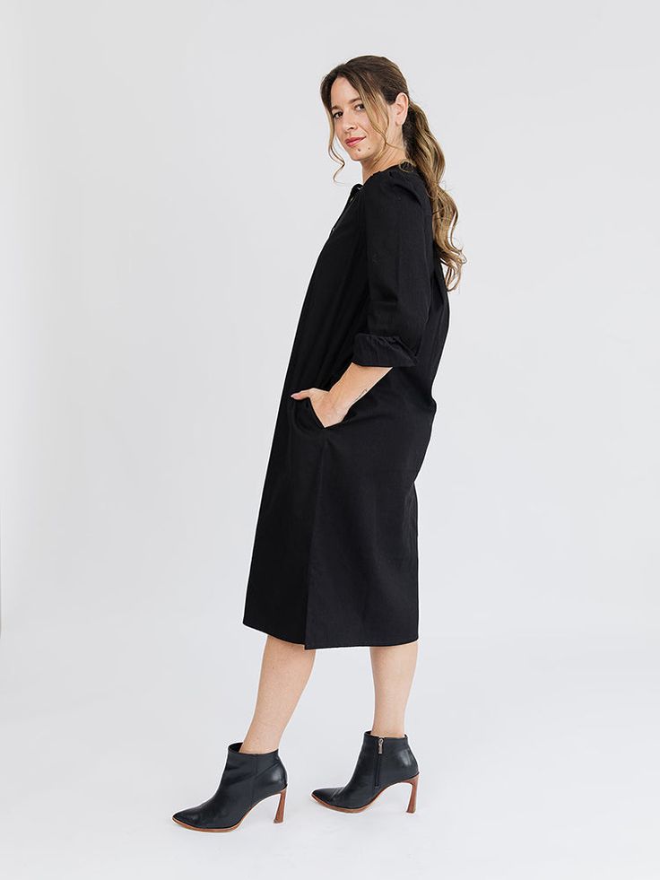 This midi dress will be a staple in your closet. Featuring hidden pockets, brass buttons, and a midi length skirt that hits mid-calf, this black dress is casual cute in canvas-weight denim cotton that's perfect for cooler weather. 100% Cotton Hidden pockets Brass buttons Length of size M is 45.75" from top of bodice Made fair trade in India by one of our longstanding production partners Chic Mid-length Cotton Denim Dress, Chic Black Button-up Midi Dress, Black Mid-rise Cotton Denim Skirt, Relaxed Fit Midi-length Medium Wash Denim Dress, Black Knee-length Cotton Denim Dress, Tencel Fabric, Fair Trade Clothing, Denim Cotton, Tiered Midi Dress