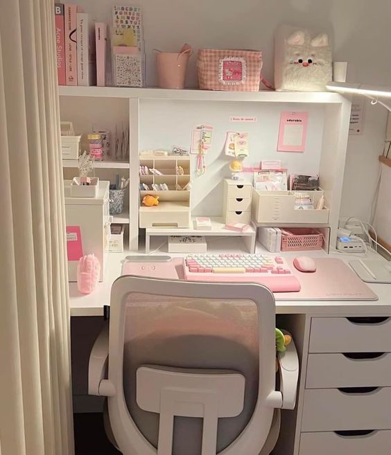 a white desk topped with a computer and lots of drawers