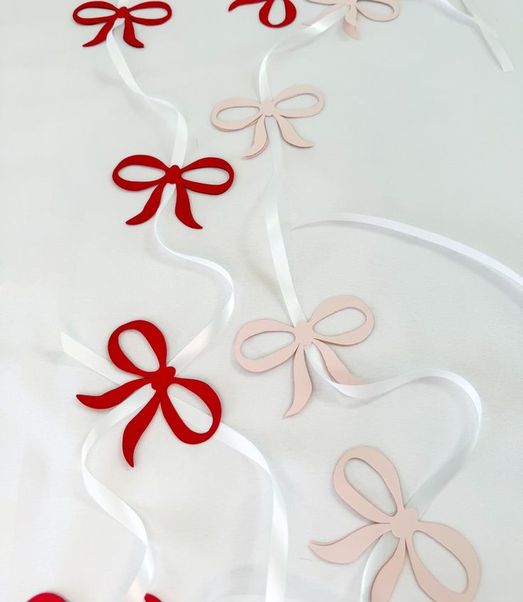 red and white ribbons with bows on them