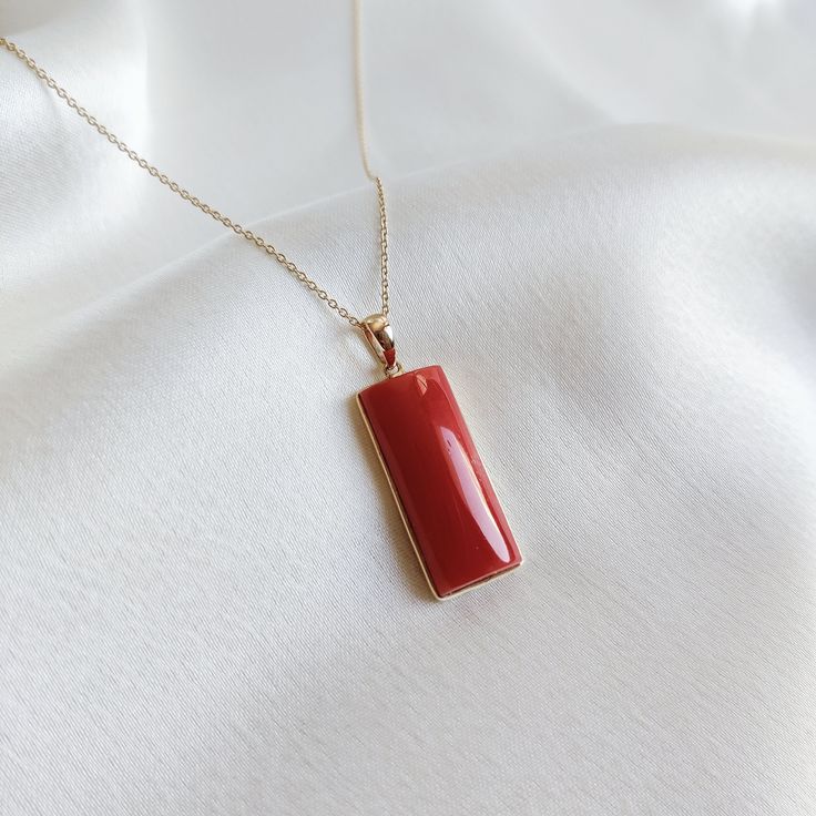 This stunning Pendant is set in 14k Solid Yellow Gold with Natural Coral with utmost precision. It is a unique gemstone Pendant for nearly every occasion and is completely hassle-free jewelry. ITEM DETAILS: * Gem: Coral * Gem Size: 10X24mm * Gem Shape: Rectangle * Gem Weight: 15.49 carats * Gold Purity: 14KT  * Gold Weight: 0.71 gram * Total Weight of the Pendant: 3.81 gram The Gold purity is guaranteed and it comes with authentic 14KT gold hallmark. Since my items are handmade, they are absolut Fine Jewelry Rectangular Pendant As Gift, Fine Jewelry Necklaces With High Luster As Gift, Fine Jewelry Necklace With High Luster For Gifts, Fine Jewelry With Red Rectangular Stone, Red Rectangular Stone Jewelry For Gifts, 14k Gold Rectangular Gemstone Jewelry, Red Rectangular Stone Jewelry Gift, Luxury Necklace With Rectangular Stone For Gift, Luxury Rectangular Stone Necklace For Gift