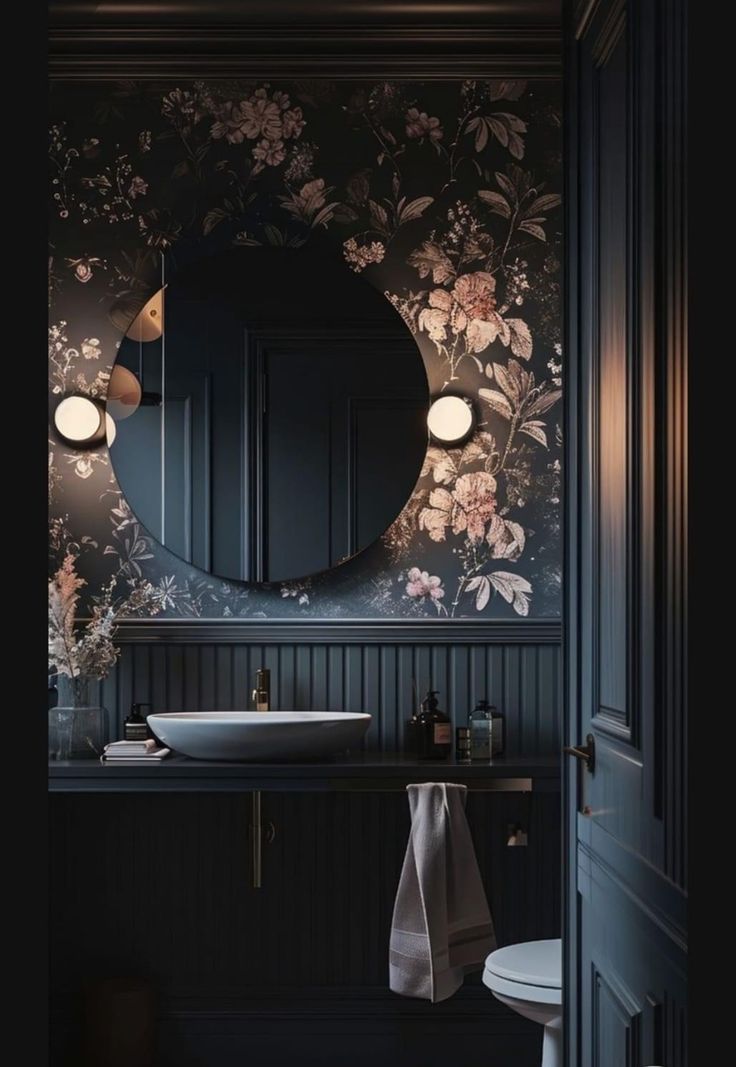 a bathroom with a sink, mirror and lights on the side of the wall in front of it