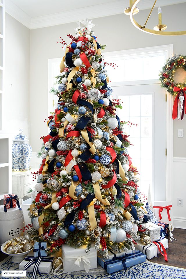 a decorated christmas tree with red, white and blue ornaments