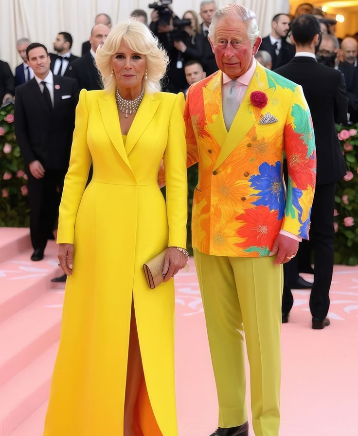 a man and woman in yellow outfits standing next to each other on a pink carpet