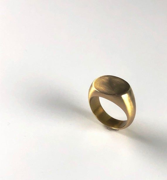 Timeless, large, oval signet ring in 14k gold plated over sterling silver with a satin finish.  Women can wear it as a statement ring and men can wear it as a traditional pinky signet ring.  This ring was handmade and hand carved by me using the lost wax method in my studio in NYC.Personalize your signet ring with an engraving for $20.  You can have up to three letters engraved on your ring.  Choose the option with engraving and then fill out the personalization option with your desired letters. Oval Tarnish Resistant Signet Ring For Everyday, Yellow Gold Oval Dome Ring In Brass, Gold Oval Ring With Smooth Finish, Oval Jewelry With Smooth Finish As Gift, Oval Jewelry With Smooth Finish For Gift, Gold Oval Brass Signet Ring, Modern Brass Signet Ring With Polished Finish, Gold Oval Engraved Brass Ring, Oval Brass Promise Ring