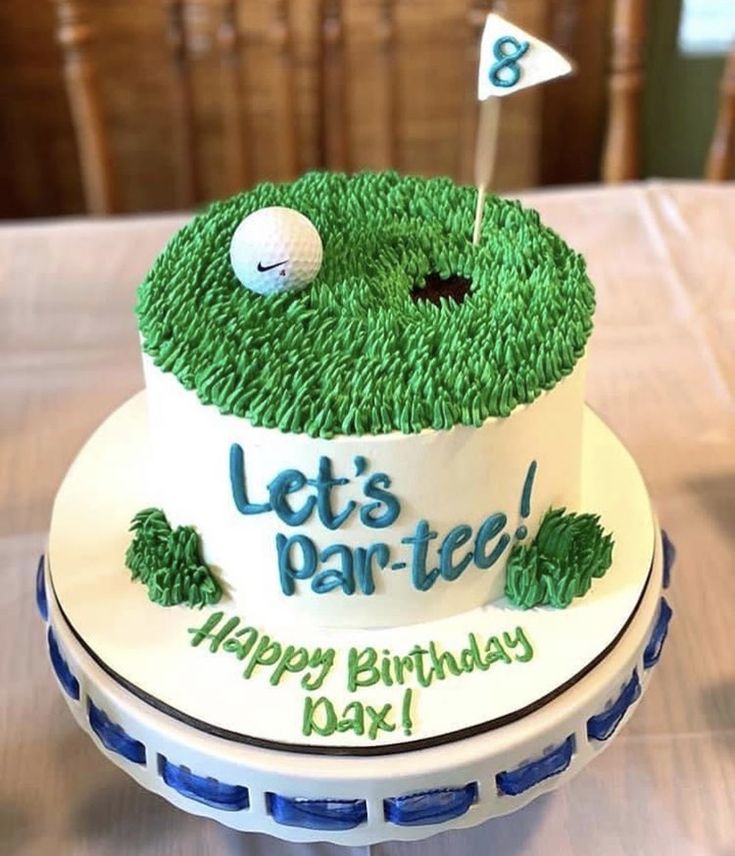 a birthday cake with grass and golf balls on it