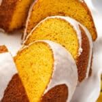 a bundt cake with white icing on a plate