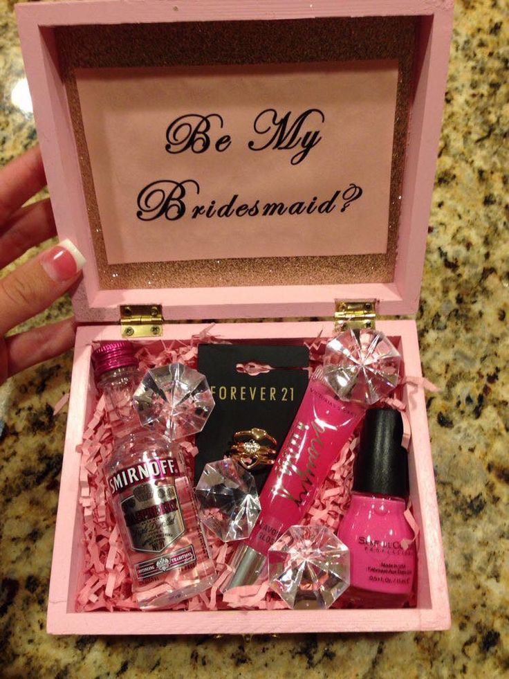 a pink box filled with different types of perfumes