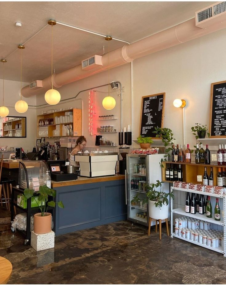 the inside of a restaurant with tables, chairs and menus on the wall behind the counter