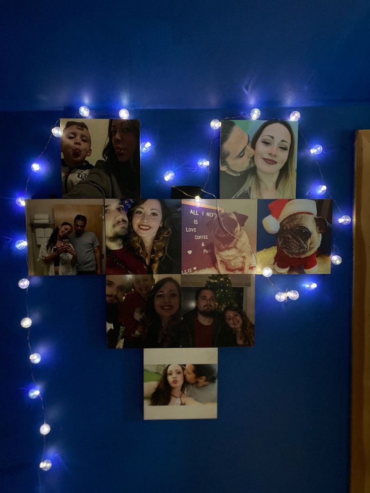 the wall is decorated with many pictures and lights in blue hues, along with white string lights