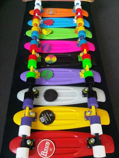 a row of colorful skateboards sitting next to each other