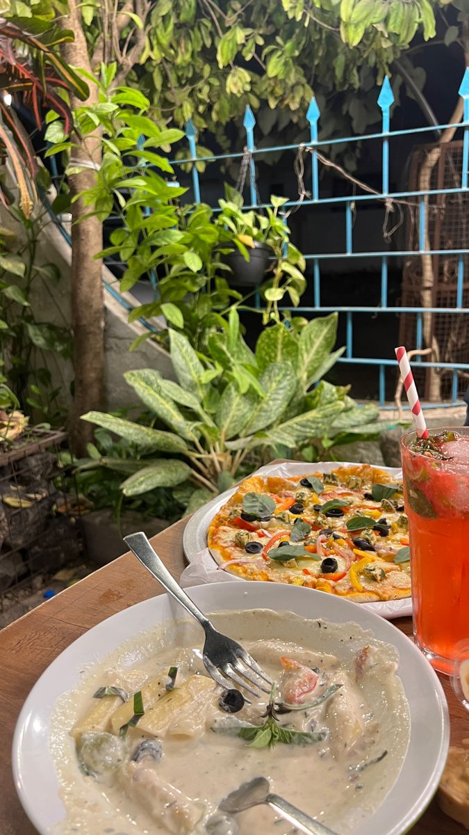 a table topped with plates of food and drinks