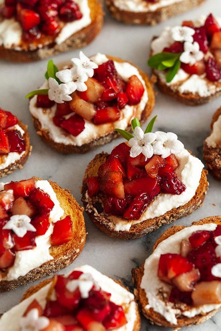 several small crostini with ricotta and strawberries on them are shown here