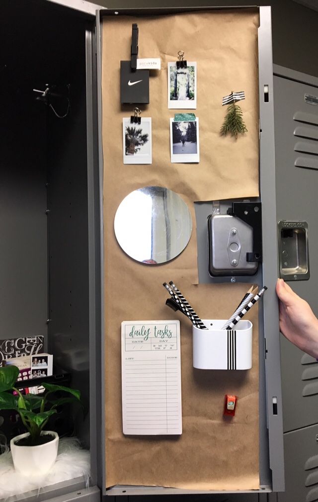 an open locker with various items on it and a notepad attached to the door