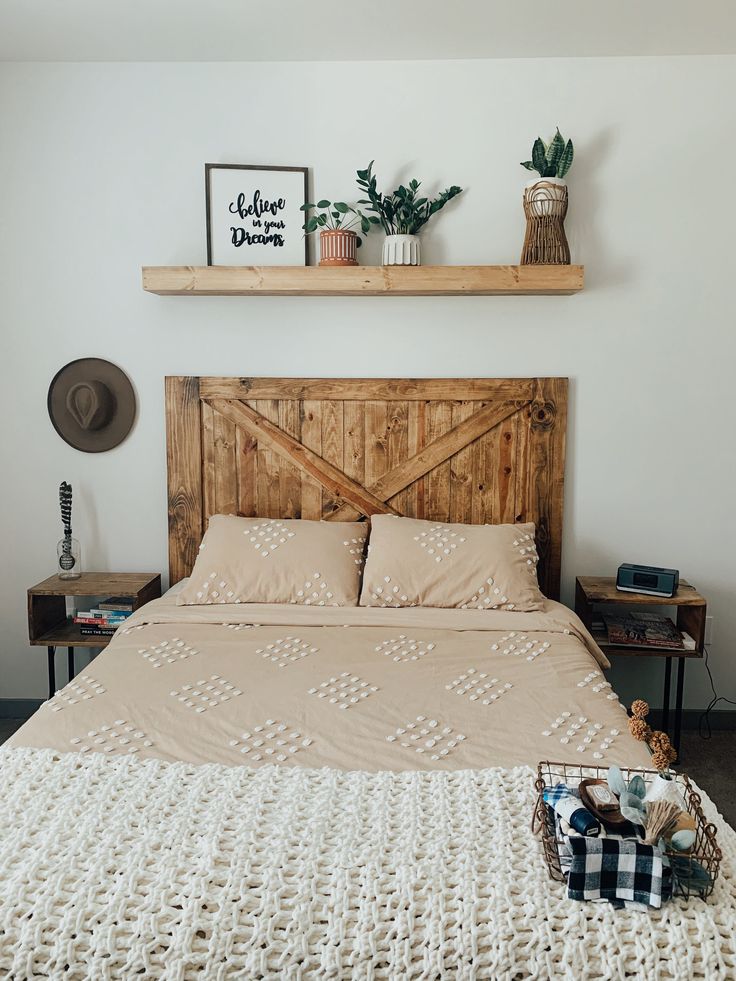 a bed with a wooden headboard and some plants on the top shelf above it