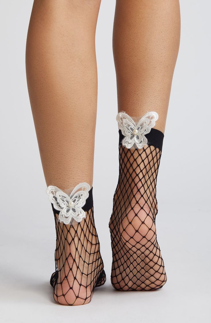 Embroidered butterflies put a whimsical spin on sassy fishnet socks edged by a wide band for a secure, comfortable fit. 85% nylon, 15% spandex Hand wash, line dry Imported Summer Party Mesh Hosiery, Party Fishnet Socks, Stretch Mesh Fishnet Socks, Stretch Fishnet Mesh Socks, Stretch Fishnet Socks Made Of Mesh, Stretchable Fishnet Mesh Socks, Fitted Fishnet Socks For Spring, Spring Fishnet Socks, Fishnet Stockings For Summer