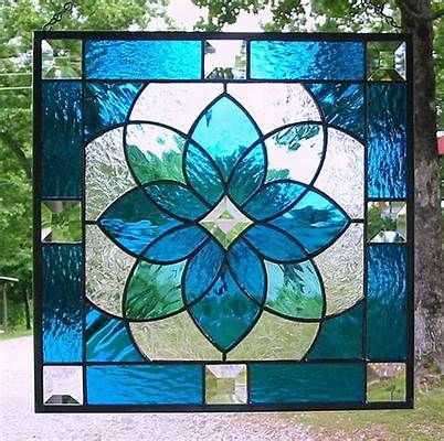 a stained glass window with blue and green flowers