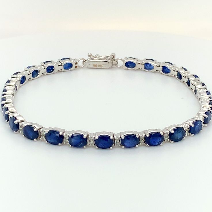 14k Sapphire Diamond Tennis Bracelet  Prong Set BLUE SAPPHIRES- SHAPE: Oval SIZE: 5x4mm # OF STONES: 26 WEIGHT: 13.77 carats DIAMOND- # OF STONES: 52 WEIGHT: 0.52 carats Gold Weight: 9.38 grams Classic Sapphire Gemstone Tennis Bracelet, Sapphire Tennis Bracelet With Round Diamonds, Sapphire Diamond Tennis Bracelet With Round Shape, Sapphire Diamond Tennis Bracelet With Round Cut, Sapphire Tennis Bracelet With Prong Setting Gift, Blue Round Tennis Bracelet With Prong Setting, Sapphire Diamond Tennis Bracelet Gift, Blue Tennis Bracelet With Prong Setting, Classic Sapphire Tennis Bracelet With Prong Setting