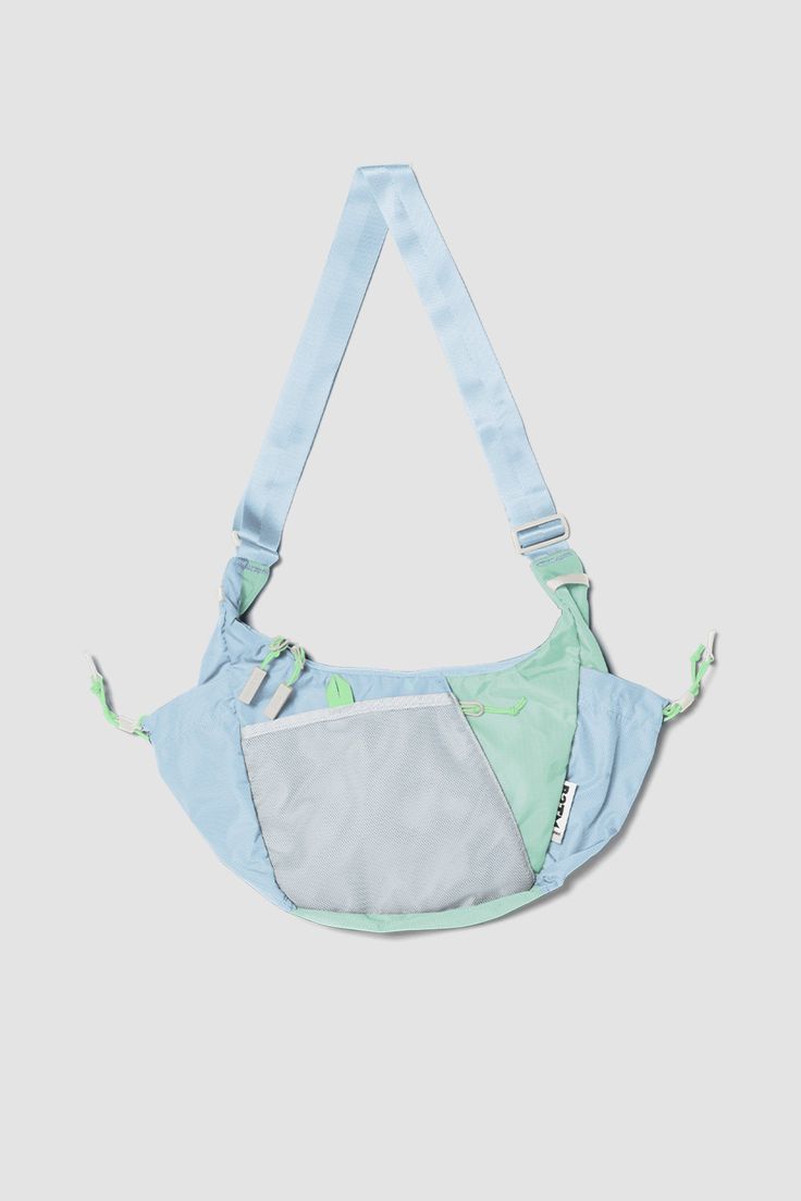 a small blue and green bag hanging from the side on a white background with an attached strap