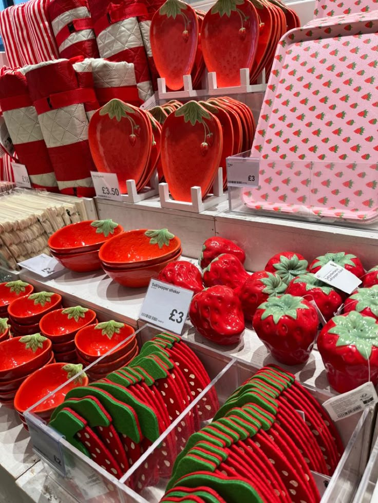 red and green plates, strawberries and other items for sale