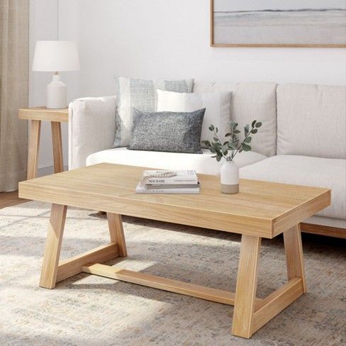 a living room with a white couch and wooden coffee table