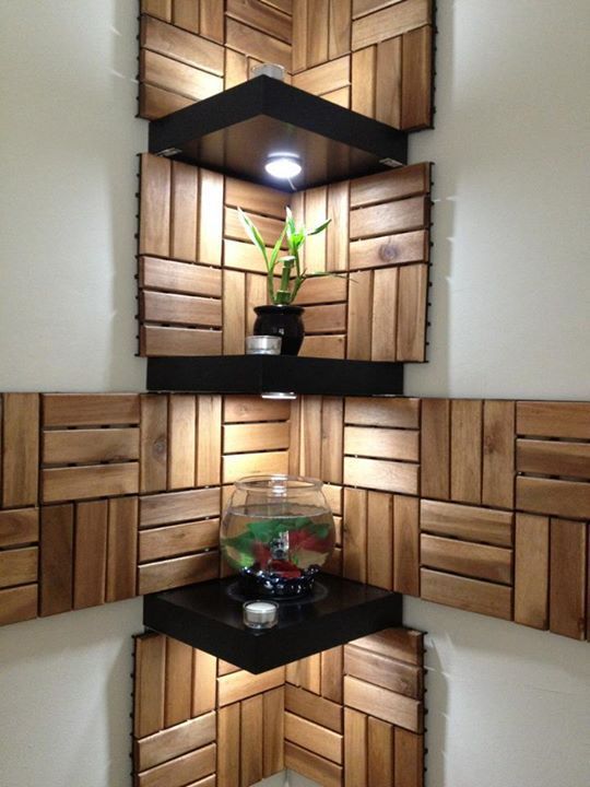 the corner shelves are made out of wood and have plants in them on each shelf