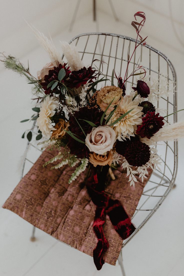 a bouquet of flowers sitting on top of a chair