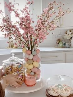 a table topped with lots of candy and flowers