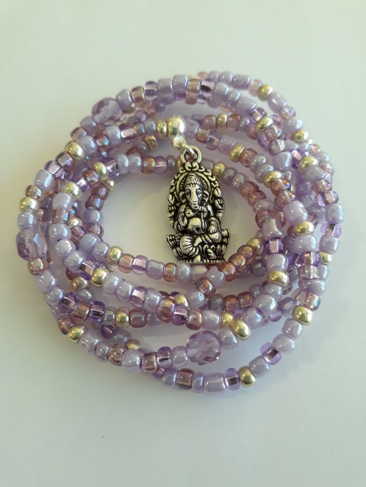 Waistbeads, made with 4mm lavender and silver glass seed beads, 6mm Czech glass beads, and pewter 'Ganesha' charm. Beads are on heavy elastic cord. Spiritual Round Waist Beads As A Gift, Spiritual Style Waist Beads As A Gift, Spiritual Style Waist Beads For Gift, Purple Spiritual Beaded Jewelry, Spiritual Purple Beaded Jewelry, Spiritual Lavender Beaded Bracelets As Gift, Spiritual Lavender Beaded Bracelets With 8mm Beads, Lavender Spiritual Jewelry With 8mm Beads, Spiritual Lavender Jewelry With 8mm Beads