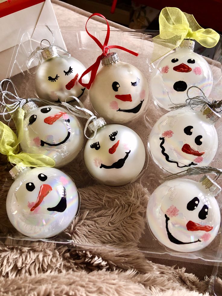 christmas ornaments with faces painted on them