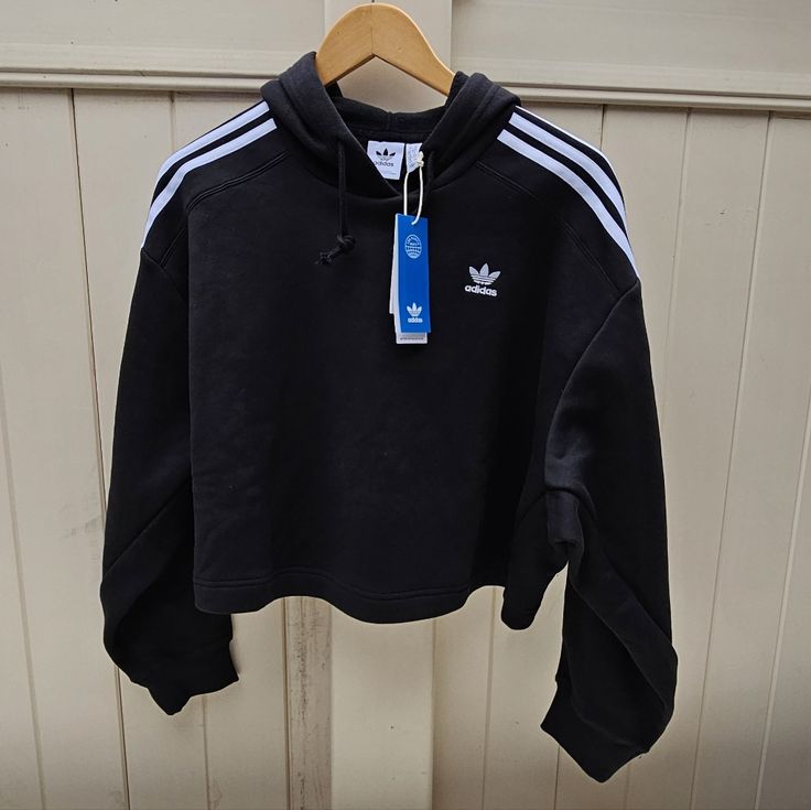 Women's Adidas Short Hoodie Black Size Medium. Sold As Pictured. Price Is Firm. Thank You Adidas Three Stripes Hoodie For Fall, Adidas Hoodie With Three Stripes For Fall, Adidas Black Sweatshirt Sportswear, Adidas Black Sportswear Sweatshirt, Adidas Black Hoodie With Ribbed Cuffs, Adidas Black Hoodie With Drawstring Hood, Casual Adidas Hoodie With Three Stripes, Black Adidas Hoodie With Ribbed Cuffs, Adidas Black Sweatshirt With Drawstring Hood