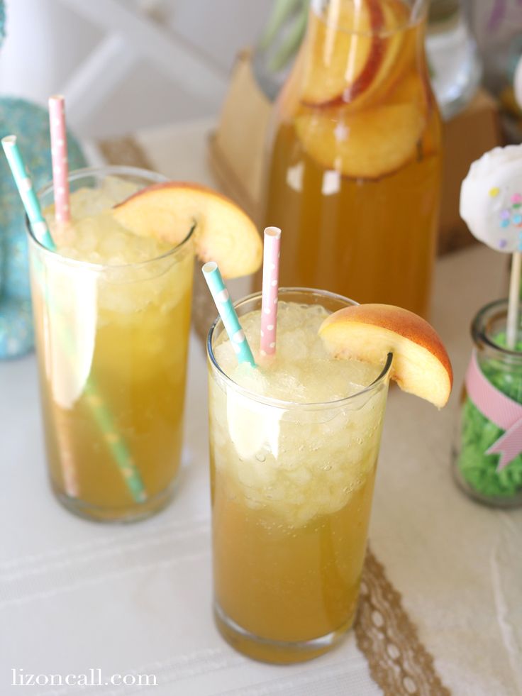 two glasses filled with drinks sitting on top of a table