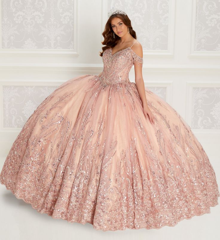 Off-the-shoulder novelty sequin ball gown with a v-neck, lace appliques and beading on the neckline, basque waist, corset back, and stone accents throughout. Sequin small cape included Pink Quinceanera Dresses Rose Gold, Quinceanera Dresses Rose Gold, Gold Dama Dresses, Rose Gold Quince Dress, Gold Quince Dress, Gold Quinceanera Dresses, Rose Gold Quinceanera Dresses, Rose Gold Quinceanera, Sequin Ball Gown