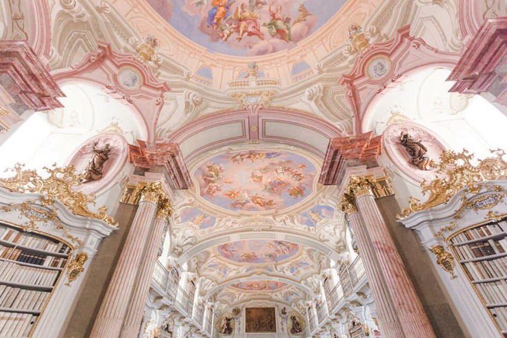 the interior of a church with painted ceilings and columns