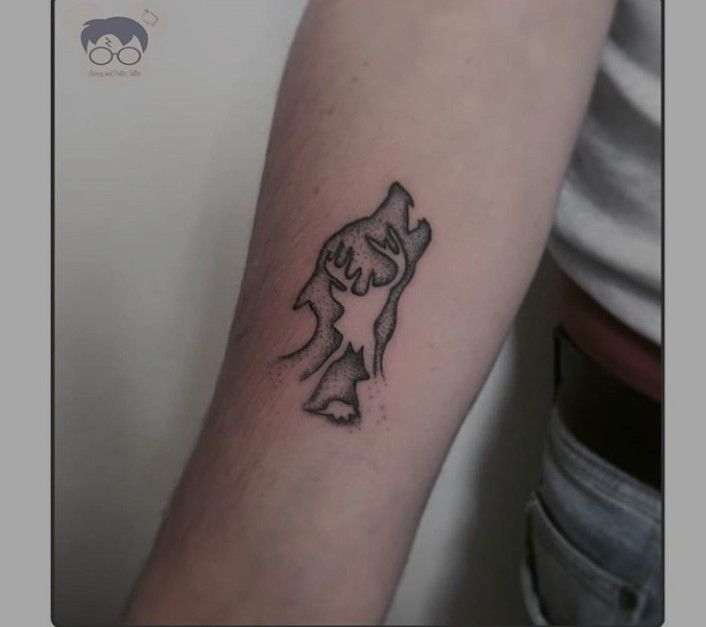 a small tattoo on the arm of a person with a dog in it's head