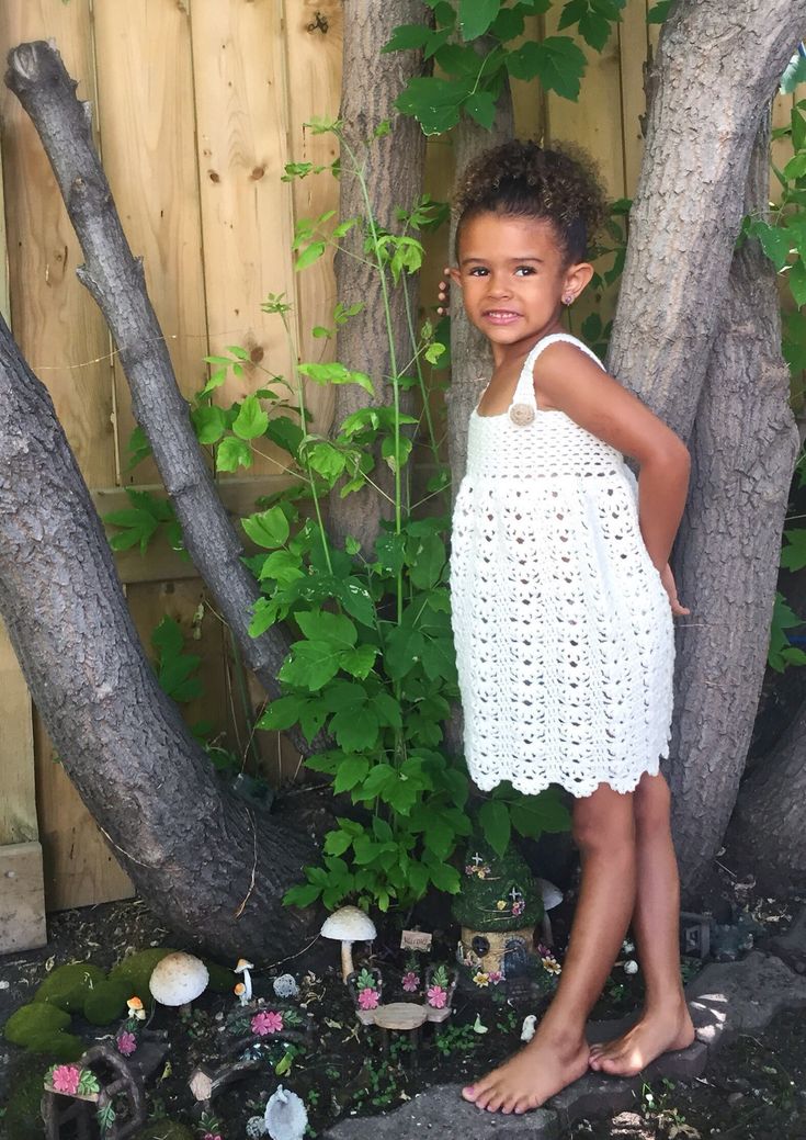 "This beautiful little sun dress is made of soft 100% acrylic yarn.  The contrasting shoulder strap and back closure beige handmade buttons add a perfect bit of color to this pretty cream dress. The bodice is form fitting while the skirt is quite full.  This is a very feminine little dress. Please hand wash in warm water only and dry flat. All items from The Whimsical Elephant are handmade by me in a smoke  free environment.  Sizing: 9 - 12 months - chest size 19\"   length 17 1/4\"          18- Cute White Suspender Dress For Summer, White Cute Suspender Dress For Summer, Cute Fitted Sleeveless Crochet Dress, Fitted Sleeveless Crochet Dress In Cute Style, Fitted Sleeveless Pinafore Dress For Summer, Sleeveless Summer Pinafore Dress For Garden Party, Summer Sleeveless Pinafore Dress For Garden Party, Cute Crochet Dress For Summer Beach, Cute Crochet Beach Dress For Summer