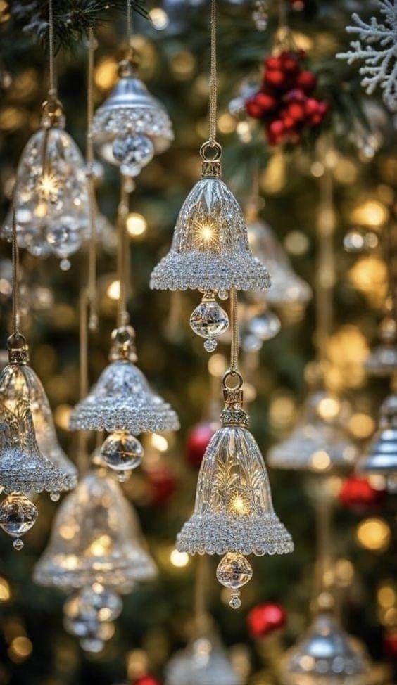 christmas ornaments hanging from the ceiling in front of a tree with lights and snowflakes