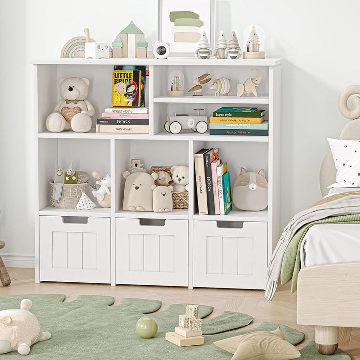 a child's bedroom with white bookcases and toy animals on the floor