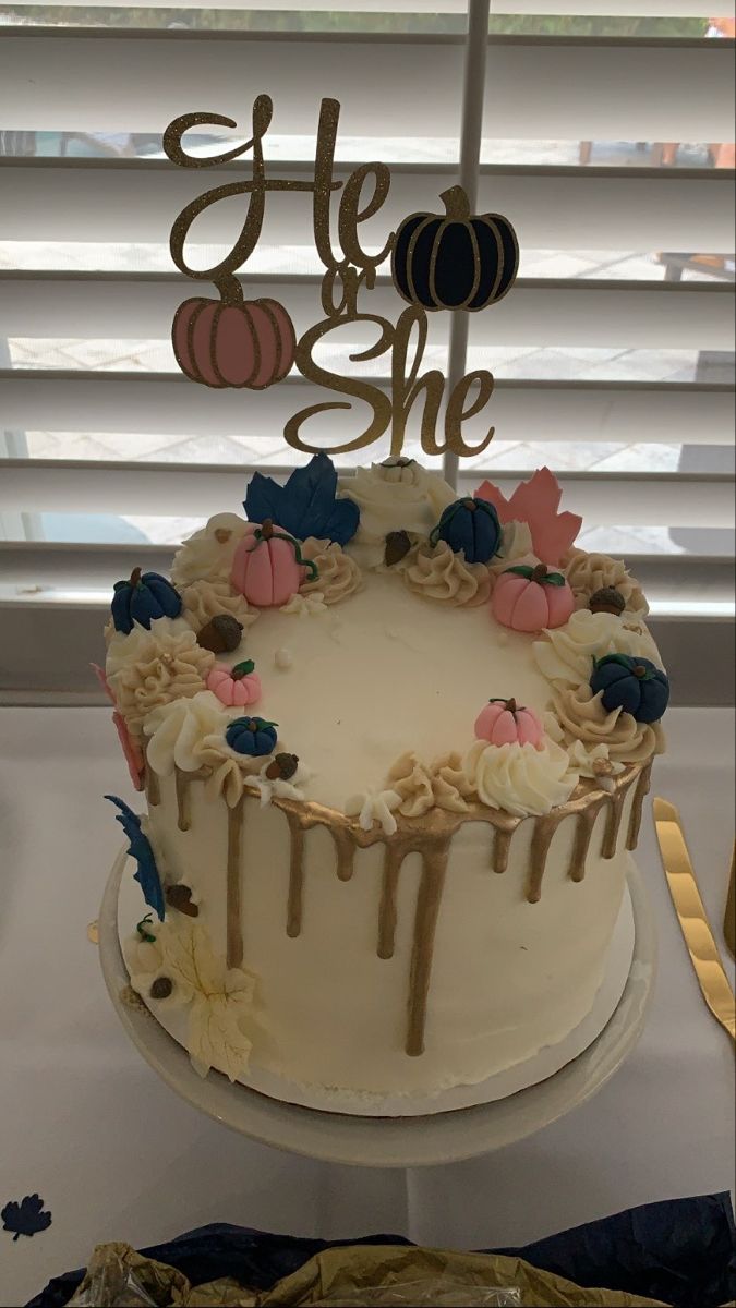 a cake with frosting and decorations on top is sitting in front of a window