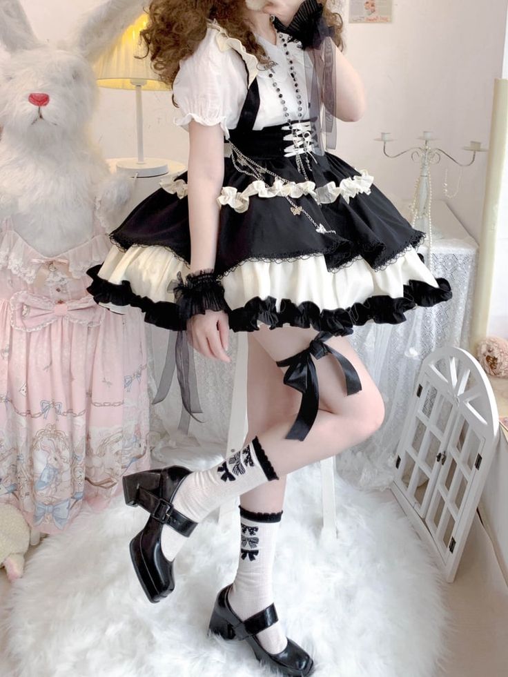 This stunning Lolita skirt features a charming black and white color scheme, accentuated by a lace-up front and a high waist design for a flattering fit. The detachable straps add a versatile touch, allowing you to customize your look. Embrace the sweet and elegant Lolita style with this beautiful skirt that is perfect for any occasion.   	 		 			Size 			S 			M 			L 		 		 			Waist 			58-82 			64-88 			72-94 		 		 			Full Length 			43 			44 			45 		 		 			Hem Circumference 			426 			426 			426 Harajuku Style Black Ruffled Bottoms, Cute Black Party Skirt, Cute Black Skirt With Ruffles, White Harajuku Skirt With Ruffles, White Harajuku Style Ruffled Skirt, Cute Fitted Black Skirt, Cute Black Mini Skirt For Party, Black Mini Dress With Ruffled Skirt, Cute Black Bottoms For Party