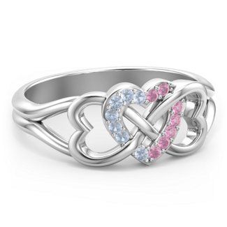 a white gold ring with two hearts in the middle and diamonds on each side,