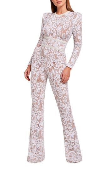 Crafted from lovely lace, this sleek and sophisticated jumpsuit features a laced-up back and flared hems. Hidden back-zip closure Jewel neck Long sleeves Lined 100% nylon Dry clean Imported Lace Long Sleeve Jumpsuits And Rompers For Party, Elegant Lace Jumpsuits And Rompers For Night Out, Elegant Long Sleeve Lace Jumpsuits And Rompers, Chic Lace Trim Jumpsuits And Rompers For Party, Chic Party Jumpsuits And Rompers With Lace Trim, Elegant Lace Jumpsuits And Rompers For Spring, Spring Party Lace Jumpsuits And Rompers, Party Jumpsuits And Rompers With Lace Trim, Fitted Lace Jumpsuit With Lace Trim