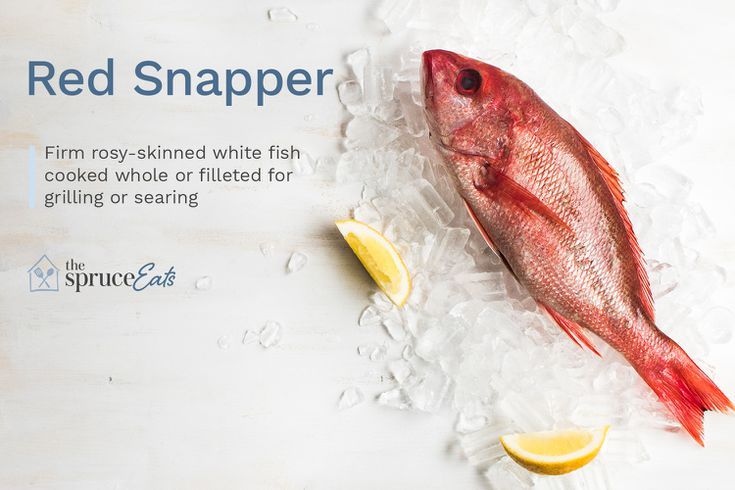 a red snapper fish on ice with lemon wedges next to it and the caption