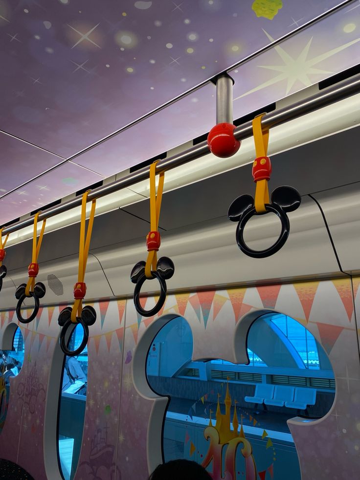 the olympic rings are hanging from the ceiling in front of an open window on a train