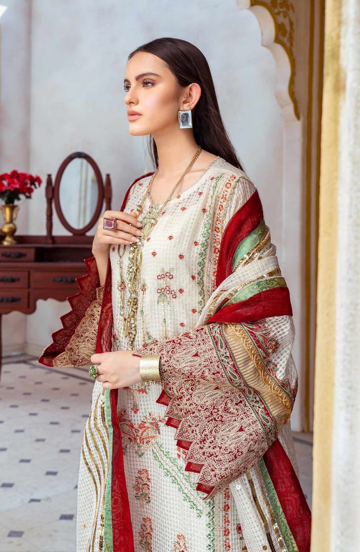 Pakistani Embroidered Salwar Kameez and Dupatta Dress come in premium fabric and it gives you a traditional look on the festive occasion. Mirror lace work, zari, threads, floral designs, and embroidery give a perfect finishing look to the Salwar kameez, making it an exquisite choice for the big day. Kameez: The beautiful kameez comes in premium check organza and is emblazoned with graceful embroidery work and threads. The sleeves and borders of the organza kameez are beautifully adorned with lux Traditional Cambric Churidar With Intricate Embroidery, Bollywood Brocade Dress For Eid, Bollywood Brocade Eid Dress, Diwali Cambric Dress With Intricate Embroidery, Elegant Unstitched Suit With Resham Embroidery For Ceremonies, Wedding Anarkali Set With Zari Work In Cambric, White Jamawar Anarkali Set With Dabka Work, Red Mulmul Salwar Kameez For Wedding, Eid Multicolor Embroidered Lawn Suit