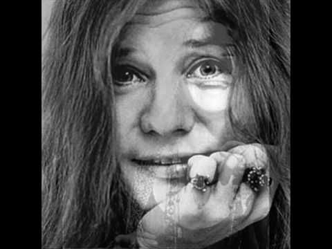 an old black and white photo of a woman with long hair holding her hand to her face