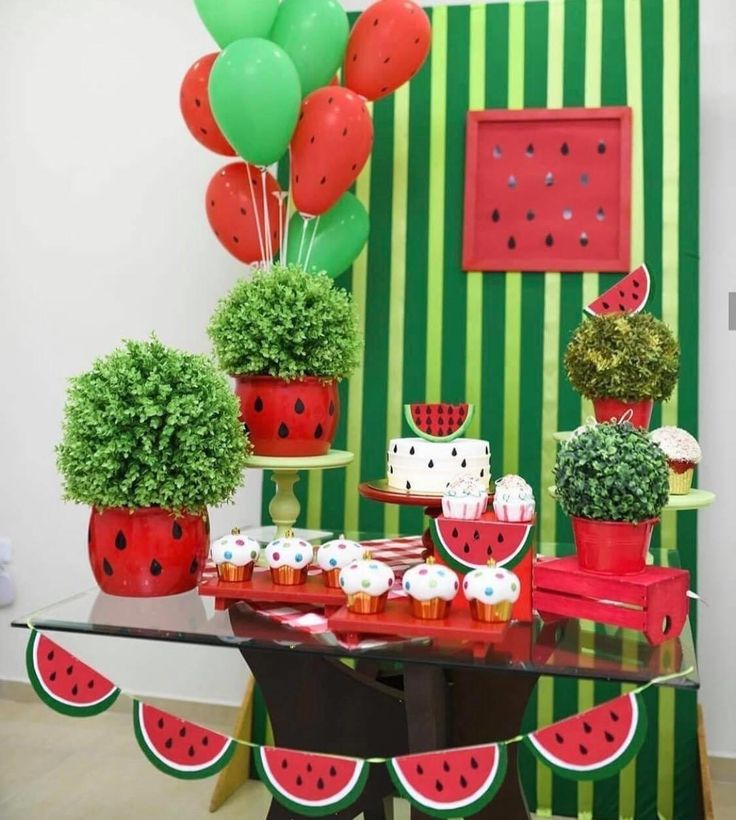 a watermelon themed party with balloons and desserts