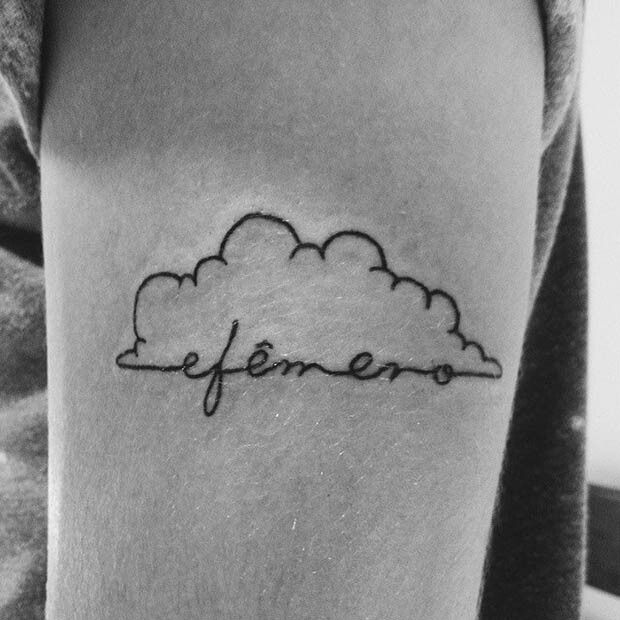 a black and white photo of a person with a cloud tattoo on their arm