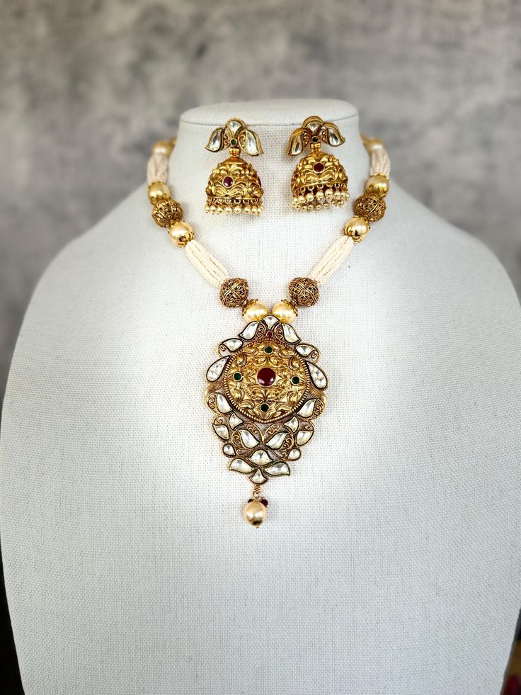 Multi pearl strand with gold beads attached with bikaneri kundan pendant and traditional jhumki's to complete the look. Perfect for any occasion parties, wedding or festivities. 22k Gold Pearl Necklace For Celebrations And Festivals, Kundan Necklaces With Latkans For Diwali, Diwali Kundan Necklace With Latkans, Kundan Chandbali Necklace With Latkans, Eid Kundan Necklaces With Latkans, Festive Tilla Chandbali Pearl Necklace, Festive Kundan Chandbali Pearl Necklace, Festive Kundan Jewelry Set With Intricate Design, Traditional Pearl Chandbali Necklace With Latkans