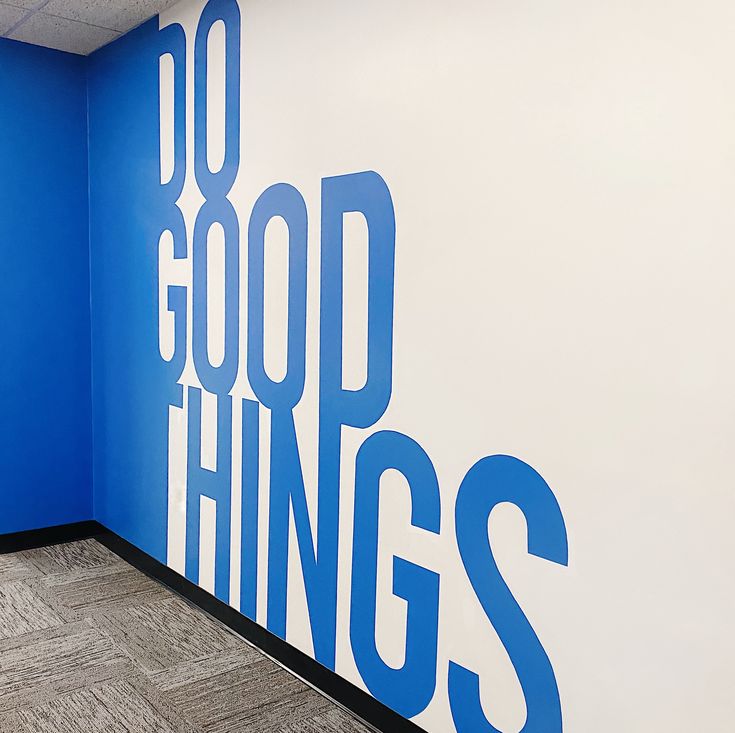 a blue and white wall with the words good things painted on it